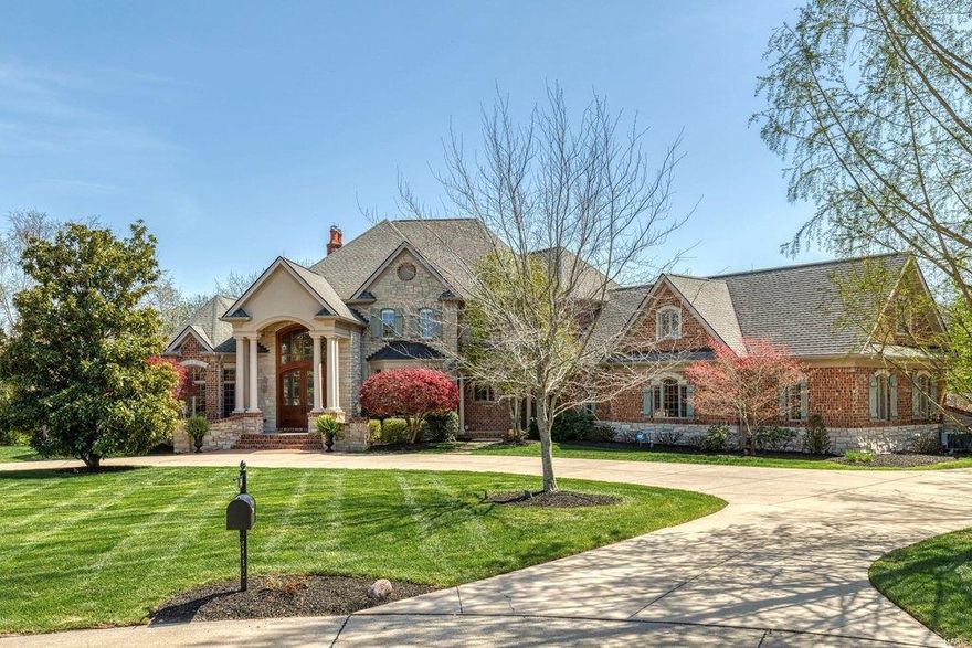 Superior craftsmanship & distinctive design elements define the architectural integrity of this European-styled Estate home. 2-Sty foyer with domed ceiling & dramatic sweeping staircase leads to library-paneled study, elegant dining room & stunning great room with architectural pillars, 2-sty bow window & marble fireplace flanked by built-in bookcases. State-of-the-art kitchen featuring cherry cabinetry, granite countertops, commercial grade appliances, 11’ center island & wet bar adjoins light-filled breakfast room & hearth room highlighted by floor-to-ceiling stone fireplace. Coffered master bedroom suite with beautifully appointed bath offers an appealing retreat. Front & rear staircases access 3 additional ensuite bedrooms, bonus room & 2nd laundry. Lower Level includes recreation room with wet bar, game room, media room, family room with 3rd fireplace, workout room & guest suite. Situated on a wooded 3-ac lot with deck, patio & resort style pool surrounded by landscaped gardens. Additional Rooms: Wine Cellar