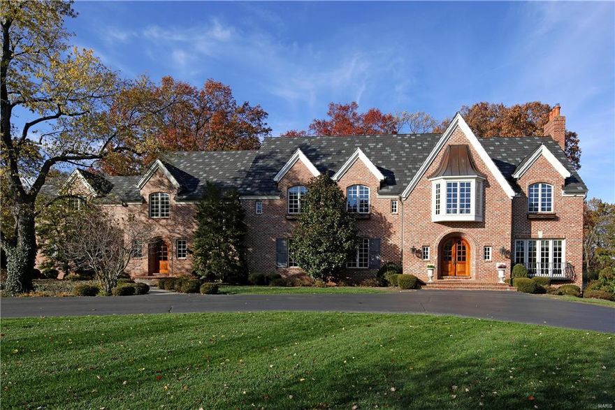 Magnificent 14 years new all brick custom home with exquisite architectural elements, fresh modern colors and updates throughout.  Starting with the front to back grand foyer with curved staircase that shares the living room with French doors and FP. Formal dining room with FP and boxed beamed ceiling flows into the fabulous butler’s pantry and newly refined gourmet kitchen which transitions in to the double height hearth room with large bay and French doors to the large rear terrace. His/hers studies, laundry room and two powder rooms complete the main floor.  Upstairs the master suite with FP and sitting room adjoins the dressing room and luxury bath with steam shower. 3 en suite bedrooms, sitting room, bonus room and laundry room complete the 2nd. Finished w/o LL with exercise, rec room, FR w/FP, full bath and possible extra bedroom. 4 car oversized garage, pool, generator, storage garage & parklike 3 acre lot.