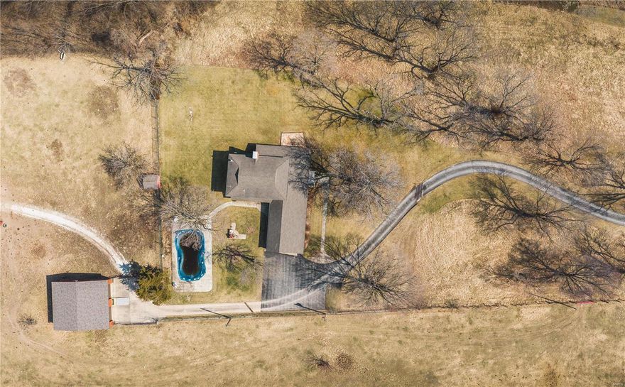 MOTIVATED SELLER !!!!! Want a home setting on a bluff that over looks the Mississippi River Valley. Well here is the Mid Century Modern home sitting on 4.79+/- acres. This was the place to be in the day as the owners used to entertain in this home A LOT. It's in town but NOT listed in the city limits of Elsberry. Built in 1954 it is a Brick home with tons of room, attached 2 car garage 3 bedrooms with original Hardwood floors Upstairs. Down stairs has a main floor family room with a fireplace, Den with a fireplace, full bathroom and main floor laundry, Kitchen, Breeze way summer room between the Kitchen and Garage. It is a well maintained home for its age. Inground pool ( needs some TLC )and Detached 2 bay Garage big enough for an RV.
Home is being SOLD AS IS... Home can be purchased with more acreage (6k an acre) at buyers expense for survey to add acreage.
Duplicate Listing of MLS# 21013052