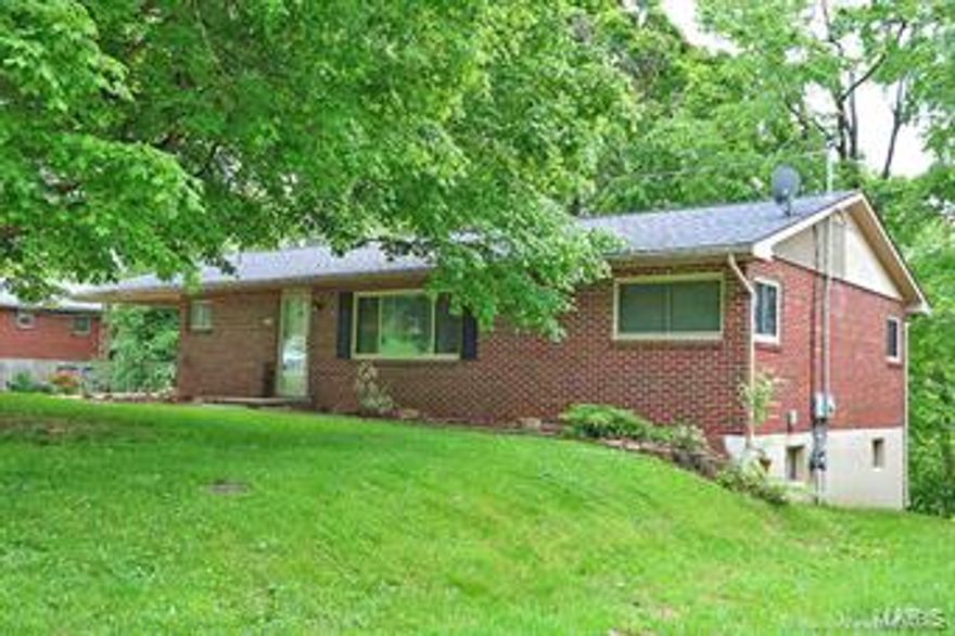 Updated all brick ranch style home, but kept true to its 1950s charm!  Restored original hardwood in living, master, hallway.  New roof, some new windows, new counter tops and neutral interior paint. Basement is a full walkout with finished bathroom. Central heat and air,  with additional wood burning furnace (negotiable), for low, efficient heating costs.  Large deck and patio with beautiful treed backyard.