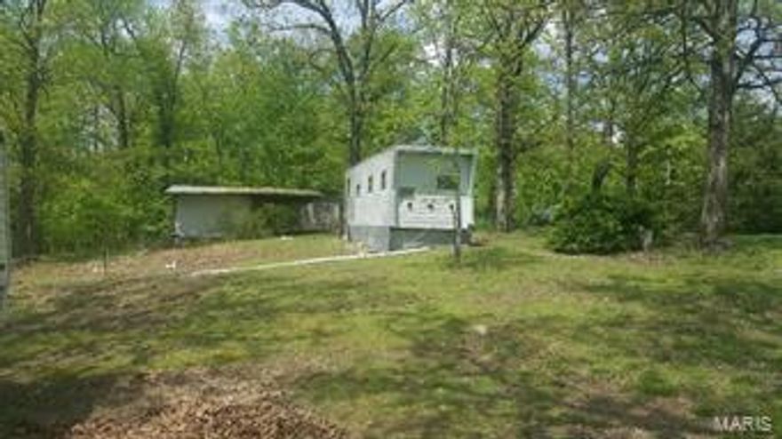 Beautiful 3.038-acre lot in Wappapello Lake area.  Property butts up against the Corps of Engineers lake property.    The lot has road frontage, with a very nice cleared area, and Currently, there are 2 camping trailers on the property, but the owner is selling as a vacant land lot.  There is also a small shed with overhang, perfect for storing a boat etc.  The property has county water, electric, and a septic system.  Septic system condition is unknown.  Possibilities of a lake view with some tree clearing.