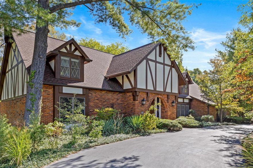 Nestled in a sought-after neighborhood, this Tudor-style gem offers a blend of character, charm & modern comfort, awaiting your personal touch. Besides great outdoor entertaining spaces, there's terrific indoor entertaining space starting with the cathedral great room connected to the bright kitchen; the ample 4 season room off the kitchen overlooks the cultivated gardens and pond. The home features rich architectural details, including classic wood beams & elegant accents that reflect the timeless style. The main floor primary suite offers convenience & privacy. The living room boasts a grand fireplace, perfect for gatherings, while large windows flood the room with natural light. The sprawling landscaped lot offers serenity & escape and is a lush oasis w/flowering plants and many special trees & native plants and private trail. LL w/full bath & rec room walks out to indoor lap pool & yard. Enjoy old-world elegance w/proximity to shopping, country clubs & schools.