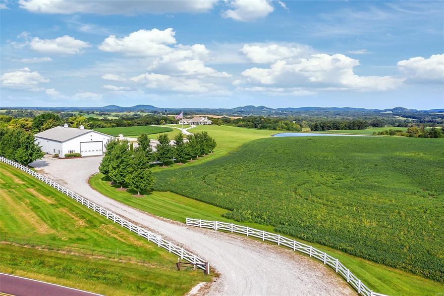 Once in a lifetime opportunity to own a PIECE OF PARADISE!  Located in the rolling hills of Eolia, MO this ONE-OF-A-KIND 150-acre estate features a gorgeous CUSTOM HOME, 6500+- sq ft MORTON BUILDING w/ LIVING QUARTERS, STOCKED LAKE, and MILLION-DOLLAR-VIEWS.  3 Bed/3 Bath home has walls of windows showcasing spectacular location!  Open living space w/vaulted ceilings, gas fireplace, gourmet kitchen, and formal dining area are perfect for entertaining or enjoying quiet evenings w/ family. Master suite has an exquisite bath, large closet, cozy gas fireplace and opens to sun porch overlooking the hot tub, stocked lake & amazing sunrises.  Accessible 3rd bathroom.  Morton building has 1168+- sq feet of living quarters, 44 x 42 fully insulated shop & 60 x 60 equipment storage.  Fully stocked lake w/ covered dock & graceful fountain.  Fertile farm fields & woods teeming with wildlife make up the remainder of this amazing estate. Hunt, Fish, Farm, Enjoy Life! See features list for add’l info. Some Accessible Features