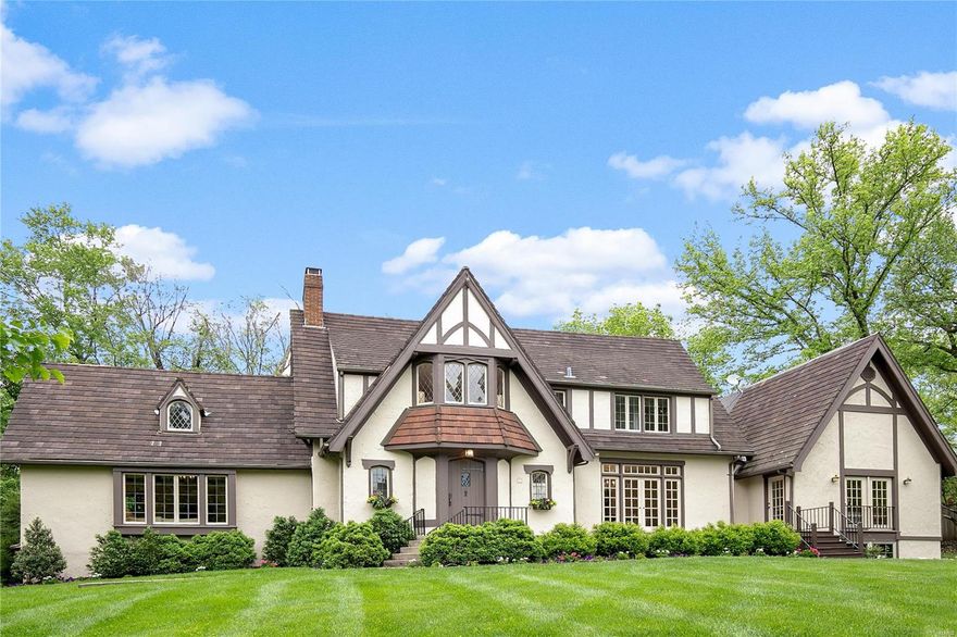 GREAT PRICE REDUCTION!  Exuding charm, this 4 bedrm, 3.5 bath tudor home is perfect for family and entertaining your friends from the neighborhood.  Situated on a private 1.5 plus serene acres with pool, this home opens at every turn with beautiful French doors leading out to gorgeous patios from your formal dining rm, family room and main floor master suite.  The kitchen with stainless appliances, custom cabinetry and stone counters is the heart of the home opening to the breakfast room and the family room with wet bar.  A laundry/mudroom and guest powder rm complete the first floor.  A bedroom suite with walk in closet and 2 other bedroom with hall bath are found on the second floor.  The 3rd floor is a perfect rec room.  The unfinished lower level has a high pour under the Master addition that can be finished to your specifications.  Such a beautiful setting in the heart of Ladue, walkable to Ladue schools and shops.