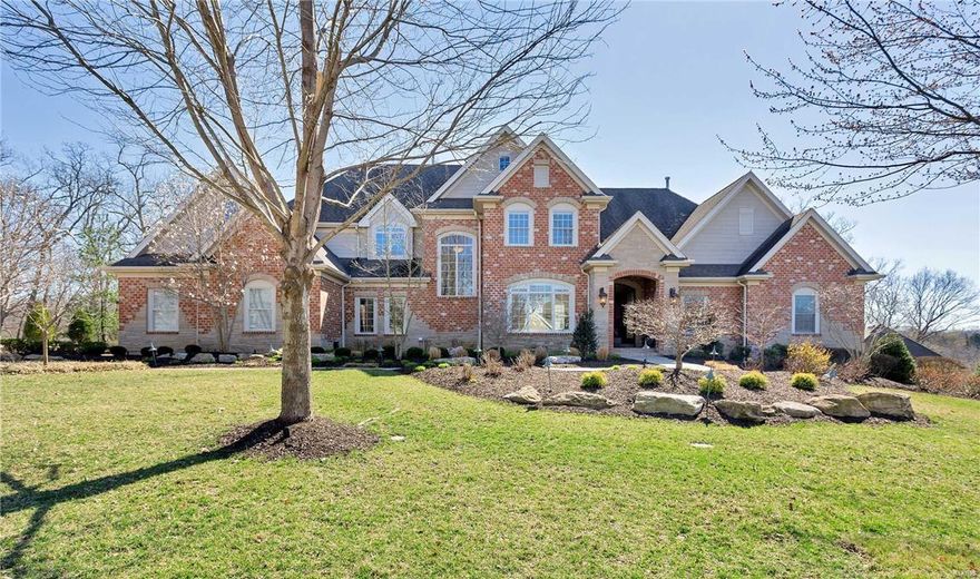 This incredible 1.5 story home sits on a picturesque 1.2 acre lot in Sunset Hills. Striking details like 10 foot coffered ceilings, plantation shutters and warm natural light fill every corner of this 4 bed/6 bath custom build.  The open, airy kitchen/hearth room means gatherings can include everyone, with impressive stone fireplace anchoring the space. Features like a large center island, 5-burner gas cooktop, double ovens and 2 dishwashers make every day tasks a true pleasure. The main floor master suite includes a gorgeous fireplace, separate vanities and double walk-in closets.  On the second floor you’ll find 2 bedrooms, each with private baths, and a bonus space complimented by built-in bookcases and window seat.  This lower level is an absolute show stopper, 2,800 sf complete with family room, wet bar, bedroom ensuite, and an office, creating an entirely private second living space.  Walk out to a stone patio, pergola and incredible views. Note: 3-car garage, main floor laundry.