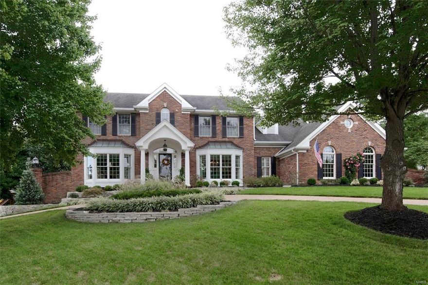 This gorgeous 2 story sits impressively on the well landscaped lot and features a newer aggregate circle drive! Impeccable and very well maintained this home welcomes you with spacious foyer- beautiful living room opening to large family room with fireplace, bay window seat, custom moldings overlooking professionally landscaped yard and  blue stone patio. Smashing New kitchen breakfast room will "take your breath away." Custom white cabinets and "state of the art appliances."   Convenient bar area btw kitchen and fam rm. ideal for entertaining.  Office and utility room on first. Exquisite new luxury master bath completes the master suite and 4 additional bedrooms and 2 additional baths on the second. The professionally finished High Pour lower level is awesome- Game room exquisite bar area and lovely TV/family room plus full bath. This home has it all!! Swim/ Tennis Club available and wonderful Warson Woods Parks. What a gem!!