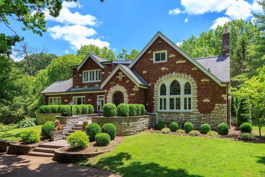Welcome to this stunning all-brick Tudor home in the desirable Webster Groves neighborhood set on over 1 acre. The chef's kitchen, remodeled in 2018, boasts custom cabinets, quartz countertops, stainless steel appliances, and a large center island. The elegant formal dining room and living room feature hardwood flooring and stained glass windows. Enjoy cozy evenings in the family room by the fireplace, or work from home in the dedicated office space.  The primary bedroom offers a luxurious retreat with a walk-in shower, heated tile floors and a double vanity. Upstairs, you'll find four large bedrooms and a fully remodeled bathroom with easy access to the newly added second-floor laundry room. The finished basement provides ample space for entertainment with a large Rec area and bar. The in-ground pool and back patio space make this home an entertainer's dream. Don't miss the opportunity to own this beautifully updated property that blends modern amenities with original charm.