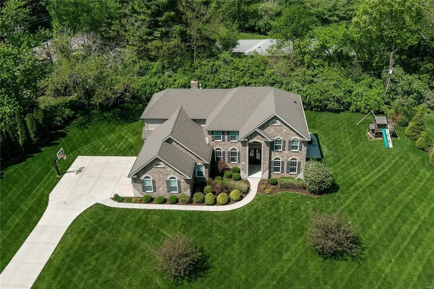 Spectacular newer construction home in the heart of Frontenac, this single owner 5 BR, 4.5 bath home has it all! Fantastic curb appeal is just the beginning - the open floor plan offers a spacious formal dining room, private office with built in bookshelves, two story living room with gorgeous windows, a dream eat in kitchen with center island, upgraded granite counters, high end appliances and walk in pantry plus a cozy hearth room which opens to the patio and large, lush back yard. There are two primary suites, one on the main level and one on the second floor- both are spacious with en-suite baths and walk in closets. Three additional bedrooms and two more full baths complete the second floor. The walk out lower level has high ceilings and awaits your ideas to finish as you desire. The large first floor laundry with cubbies and 3 car garage are an added bonus. The location can’t be beat- close proximity to shopping, schools & hospitals. Absolutely move in ready! Ladue Schools Additional Rooms: Mud Room