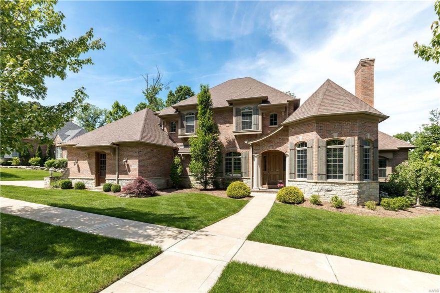 Exquisite 1.5 story French Country Estate on over an acre. Custom built Flower Home with over 5500 sq ft of living space enhanced by the finest craftsmanship with meticulous attention to detail. Impressive foyer opens to gorgeous library with stone fireplace and 12 ft beam ceiling. Elegant dining rm with elaborate molding, stunning great rm offers bow bay window w/unsurpassed views. Designer kit with custom island, granite tops, premium appliances, planning center, adjoins light filled breakfast room and hearth room with fireplace w/2 Story beam ceiling w/ access to a screened in porch w/ fireplace and ceramic tile floor. Coffered ceiling in master suite with 2 closets, lavish bath with walk in shower and jetted tub. Staircase leads to 3 bedrooms with Jack & Jill bath, separate bath & also a large bonus room ! Incredible walkout lower level includes family room with wet bar, media room, guest suite & tornado shelter. Additional amenities include 10 Ft. ceilings main floor, plus more !