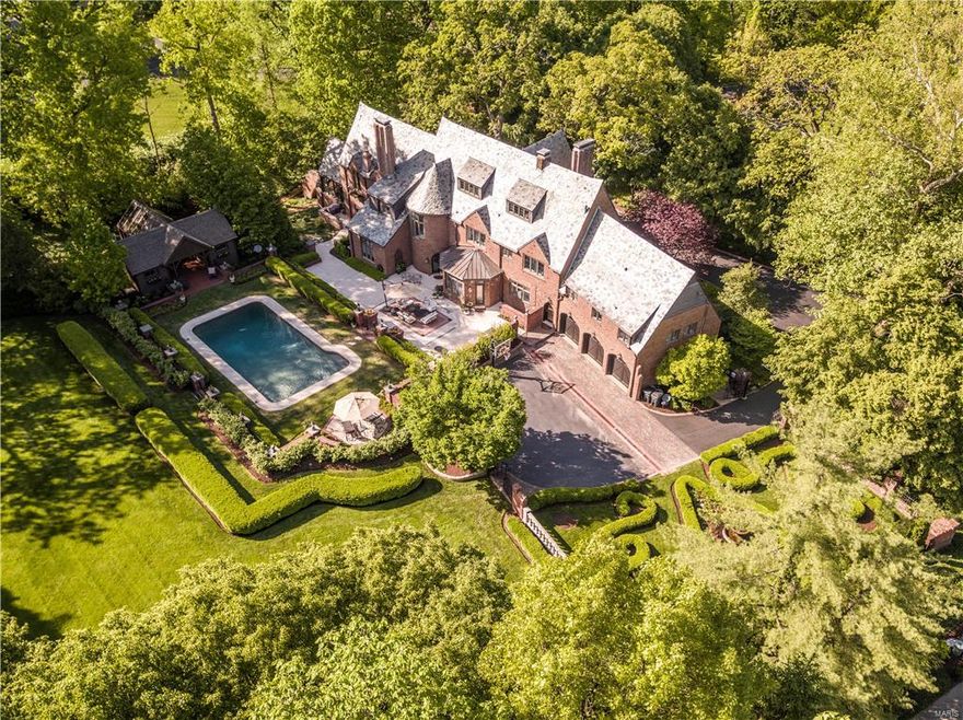 Fall in love with this enchanting storybook English Estate nestled in the heart of Ladue! An Allee of trees beckons you up the circular drive to the front entrance. The main floor delights the senses with a breathtaking foyer from which you can enjoy the Baronial living room, oak-paneled library, conservatory/office in the right wing, or the formal dining room, Chef's kitchen, breakfast room and mud room in the left wing. The grand circular staircase leads to six beautifully appointed bedrooms and baths, including the vaulted ceiling Master Bedroom, Spa Bath with his and her showers and designer dressing room. A third floor great room includes movie, workout, billiard and play areas. An airy pool house with entertainment area overlooks the Pebble-tech swimming pool. Extensive manicured grounds feature a woodland garden with mediation path, boxwood garden with European fountain, sweeping soccer-park lawn with play area. Close to shopping, parks and stroll to brunch or dinner in Clayton! Additional Rooms: Mud Room