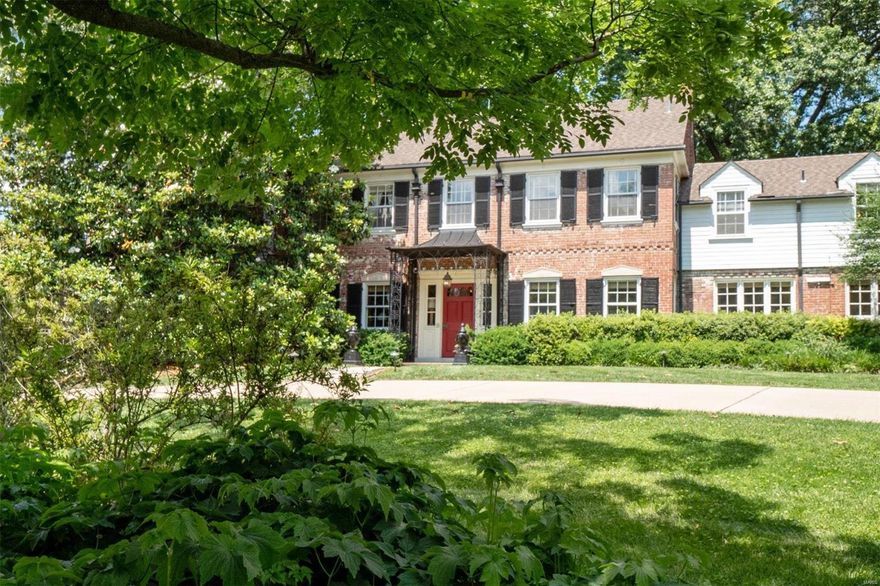 Located on the highly-coveted Dromara Road, this Gale E. Henderson-designed home honors the timeless architecture while blending modern updates for today’s lifestyle. Situated on a lush and private 1.7 acre lot, the center-entrance residence features gracious rooms designed to take advantage of the surrounding yard and gardens. The architectural details found throughout will surely impress, with beamed and vaulted ceilings, brick walls, multiple fireplaces, intricate moldings, and paneled walls.  Expanded in 2009 with a main level primary suite, dressing room with laundry, bathroom with heated floors, soaking tub, and walk-in shower. The stunning art gallery hall is lined with french doors, leading you to the covered outdoor patio. Upstairs, you will find a 2nd primary/guest suite with a walk-in closet, updated bathroom, balcony, and adjacent sitting room - plus 3 additional bedroom suites and an office/study. Geothermal HVAC, a double-width concrete driveway, and a new roof. Additional Rooms: Mud Room, Wine Cellar