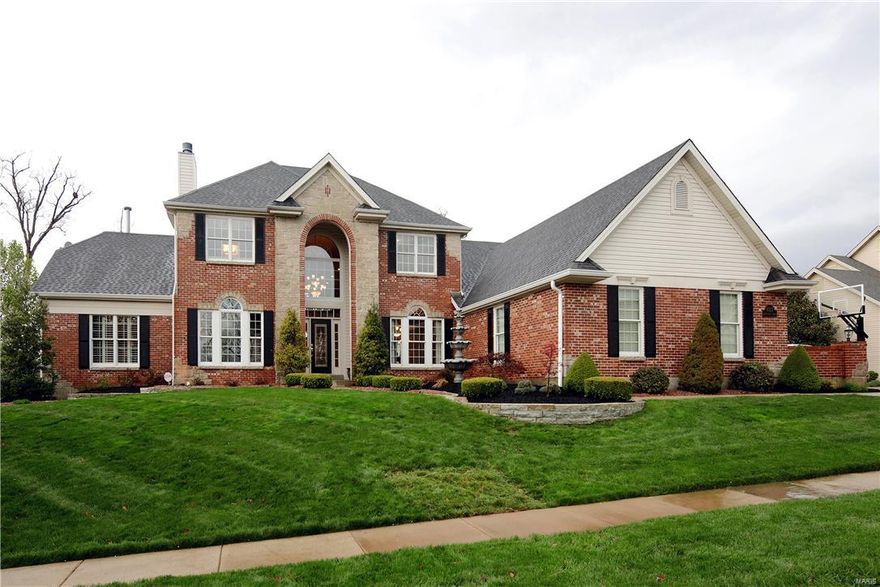 With absolutely the most beautiful view you will see,this exceptional home has a 2 story great rm,beautiful woodwork & hardwood flrs & many updates.Originally built with 120 upgrades,this discriminating owner has made continual improvements which include replacement of all windows to Pella windows which on the rear of home include many w/cellular shades-shades inside the glass.The extra large 1st flt master bedrm has fireplace & totally updated bath!A formal dining rm,large kitchen/sunroom/breakfast rm,&beautifully paneled office w/fireplace complete the 1st flr.Upstairs there are 3 additional bedrms each w/hardwood flrs & each w/full bath.The walkout LL of this gorgeous home is the icing on the cake--lovely bar area,private theatre room,two large sitting areas,exercise rm,& really beautiful full bath.Step out to what really sets this house apart-the gorgeous backyard w/it's spectacular view.You will love the stone fireplace/patio area.Don't miss the dry below deck.Newer roof,3 car gar