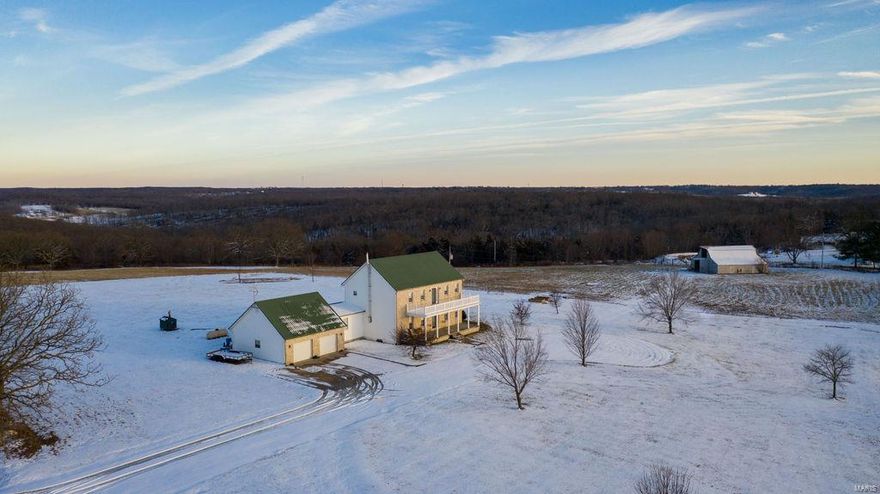 You don’t want to miss this great opportunity to own a beautiful home located just outside of Belle, Missouri. Stunning 4 bedroom, 3 bath colonial style country home with unbelievable views overlooking the historical Gasconade river valley. Complementing this home’s stunning curb appeal is its interior craftsmanship and quality. Combined with the peace of mind of a modern build. 6-inch, face nailed plank hardwood graces most home matched with a gorgeous staircase, providing a classic charm. The kitchen is large with dining room, gorgeous cabinets, island with wine cooler, and large windows allowing great views of the landscape. You'll love the warmth of the wood stove while relaxing in the massive living room. The upstairs hosts 3 bed rooms and also features a front balcony where you can sit and take in the county air while enjoying remarkable evening sunsets. There is plenty of room on this awesome 16 acres to hunt, have horses and even fish your own pond. Additional Rooms: Mud Room, Wine Cellar