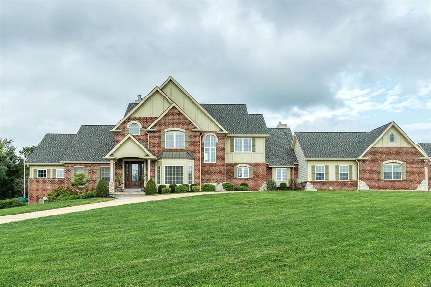 Spectacular Country Estate home on 3-acre grounds! Impressive 2-sty foyer leads to private study w/ built-in work center, formal dining room w/ bay window & stunning great room w/ cast stone fireplace, lighted display cases & dramatic wall of windows. Designer kitchen with granite countertops, cherry cabinetry, premium appliances & butler’s pantry adjoins light-filled breakfast room, vaulted hearth room highlighted by floor-to-ceiling stone fireplace & sunroom that opens to patio. Coffered master bedroom suite combines the enjoyment of a granite fireplace with luxury bath with jetted tub. The 2nd floor extends the living quarters w/ 3 additional bedrooms, 1 with ensuite bath & 2 with Jack n’ Jill bath. Walk-out Lower Level includes recreation room, game room, media area & 2nd kitchen plus workout room, craft room, hobby room & full bath. Situated on an extensively landscaped lot with patio, pool, oversized 3-car garage, auto court, detached garage & 700 sq ft carriage house apartment. Additional Rooms: Mud Room, Sun Room