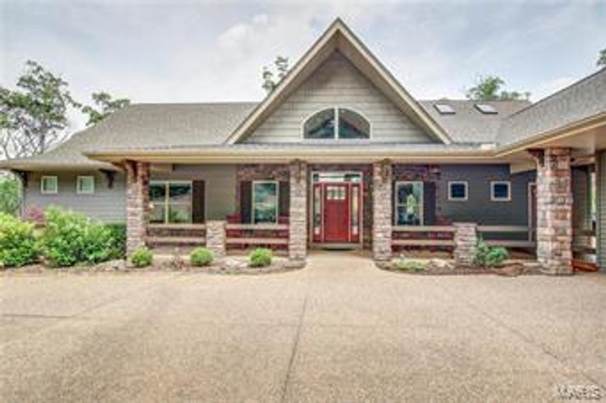 Let this new listing from Innsbrook roll out as your personal invitation to the extraordinary luxury of lake living. Located on a premier Midwest lake, this home boasts jaw-dropping views and the utmost in privacy. A manicured walkway to the large private dock will surely be a well-worn path for the home's occupants. The gentle breeze rustling the leaves is about as loud of a sound of a sound as you'll hear outdoors. Inside, the welcoming entryway is capped with high vaulted ceilings and unfolds into stunning lake views. Natural light floods throughout, covering everything from the floor-to ceiling stone fireplace in the great room to the spacious kitchen, which boasts a country flair with modern conveniences for an enviable balance of Midwest style and luxury living. The master bedroom is a private oasis with a fireplace, bay window, wood accents and vaulted ceiling. There is plenty of space to entertain guests with the abundance of outdoor decking and patio area available.