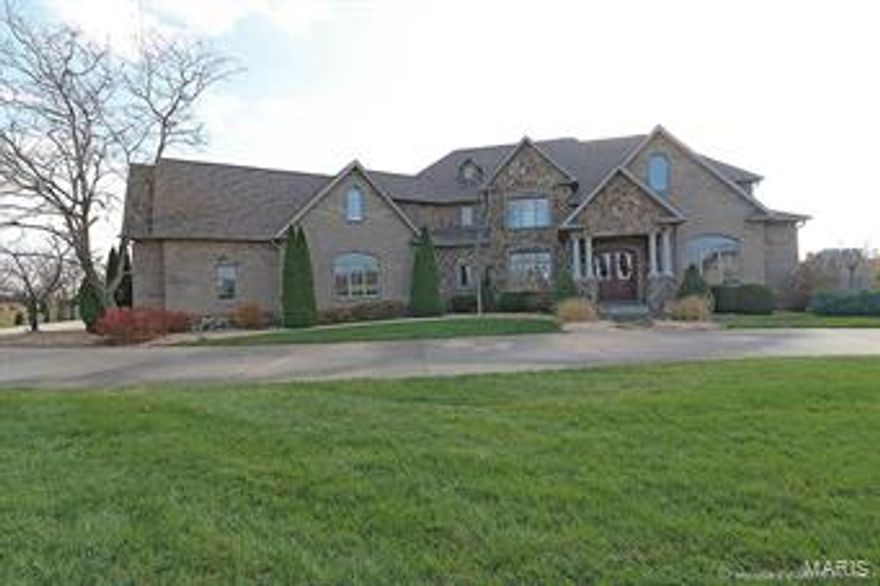 PRICE REDUCED!!
LIVE LIKE ROYALTY IN ROYAL LAKE! This estate has it all! 1.5 story brick/stone home with 7300 SF in sophisticated yet comfortable finished living space on beautiful acreage. Make a grand entrance into this home and feel the easy, open floor plan with high ceilings, crown moldings, wood flooring, and built-ins throughout.  Main level master suite has tray-ed ceiling, huge master closet with custom built-ins, a luxury bath, with custom walk-in shower. Entertain in the spacious kitchen with a center island, large breakfast bar, custom cabinets, walk-in pantry, granite countertops and high end appliances. Includes large main level laundry with custom cabinetry, mudroom with built-in cubbies, and adorable office nook.  Walkout basement is made for entertaining w/large bar, partial kitchen, commercial fridge and subzero wine chiller. Pool and black jack tables negotiable. Walk out to covered patio, outside kitchen, a 20X40 saltwater pool and great 60x80 heated outbuilding!