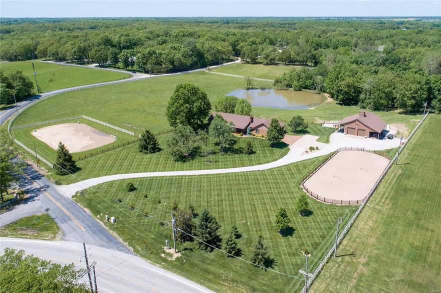 Agent owned. Amazing 10-acre Equestrian property just west of New Melle, St. Charles co, Francis Howell schools. This is one of those places that you just must see in person. Watch your riders in either riding arena from your covered front porch. Enjoy Open Concept living on both levels. 4 bedrooms, 4 full baths, Vaulted Great Room w/floor to ceiling stone fireplace, wood beam, Braz Chestnut wood floors, Bob Brandkamp custom Kitchen w/double pantries, gas cooktop, custom hood, double ovens, ss appliances, quartz counters, 8’ island, farm sink, the dining space holds farm size table. Large bedrooms with pro finished walk in closets. LL has amazing entertaining space with stone fireplace, bar/kitchenette area, bedroom, full bath, office, storage room and safe room. 2 maint free decks connect to the lower patio overlooking the beautiful pasture. Heated 4 stall Barn with grooming/foaling area, tack room, covered dry lot, covered rv parking w30amp service. Huge hay loft, all 10 acres fenced