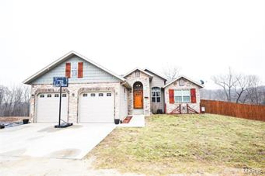 Custom built, one owner home close to Fort Leonardwood!! Gorgeous 6 bedroom home with stone front with concrete pad perfect for additional parking or for an RV. Living room features 12ft ceilings w/ gas fireplace. Open floor plan flows into the kitchen area w/ custom cabinetry, a center island, stainless steel appliances (new refrigerator and dishwasher), & soft close doors. Dining room nook located off the kitchen and walks out to the back deck. Master bedroom located on the main level. Luxurious attached master bathroom with his & her closets, double vanity, separate tub, and tiled shower. Two more large bedrooms and another full bathroom located on the main level. Lower level boasts 9 ft ceilings, spacious recreation room with walk out to backyard, laundry room, THREE more bedrooms & another full bathroom. Multi-level decking leads to an above ground pool and firepit perfect for entertaining. Rec room also holds hook up ready for a wet bar. Call today before this property is sold!!