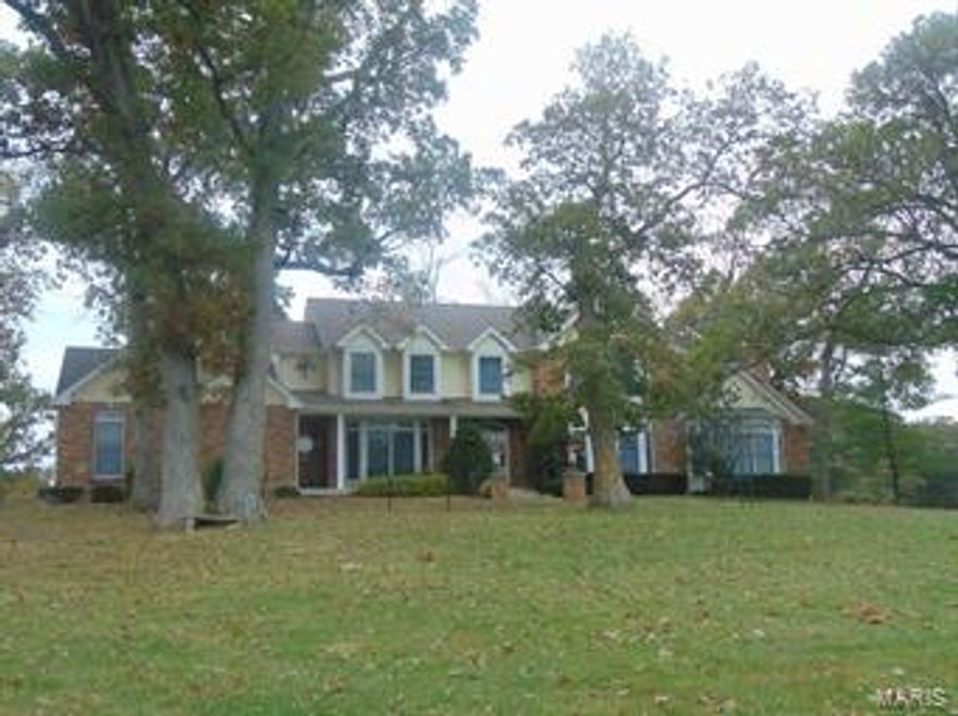 212 +/- acres-fronting Hwy D, combination of woods & pasture, approx. 30% in pasture & food plot.  Improvements include a 1 1/2 story brick and frame home built in 1993. Features include: gourmet style kitchen, spacious living rm with fireplace, formal dining rm, huge game rm with stone fireplace, 2nd story has 4 bedrooms and 3 full baths. Huge master bedroom suite has a raised Jacuzzi & separate walk-in shower! Attached 3 car garage, full basement, covered front & back porches, and unbelievable views! Gated entrance with white vinyl fence lined driveway!  All electric, septic, public water. Additional Rooms: Mud Room