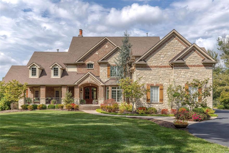 An impressive brick & stone elevation highlights the remarkable curb appeal of this spectacular 1.5-sty Estate home! 2-Sty slate foyer leads to private study with custom built-ins, elegant dining room and stunning great room with wet bar, floor-to-ceiling stone fireplace flanked by bookcases & 2-sty wall of windows. Chef’s kitchen featuring 42” cherry cabinetry, granite countertops, premium appliances & 10’ center island adjoins sunlit breakfast room & hearth room with stone fireplace. Sumptuous master bedroom suite offers an appealing retreat with His & Hers walk-in closets, wide bay window & marble bath. The 2nd floor extends the living quarters with 3 additional bedroom suites & bonus room. Walk out Lower Level includes family room, recreation room with fireplace & wet bar, 5th & 6th ensuite bedrooms & pool bath. French doors open to outdoor living area with resort style pool with waterfall surrounded by landscaped gardens plus stamped concrete patio with stone fireplace & pergola. Additional Rooms: Mud Room