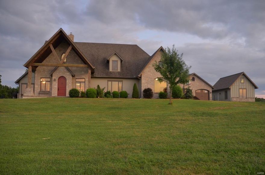 Without a doubt this ranch located just 6+/- minutes north of Rolla is a home that has everything one could ask for when looking at dream properties. The long private drive takes you by the stocked pond, across the stream and up hill where you are welcomed by the most incredible view of the beautiful Ozark countryside and then the fabulous home which was built with everything that you could imagine. Walking in you will notice the large 2 story stone wood burning fireplace with a sitting area the large modern kitchen w/ granite counter tops and all the extras. The house has many large windows which allow the natural light to show off the views, the wood floors and the radiant heated floors with stained concrete. Great thought was put into this house with a mud room in the back entrance, two laundry rooms, sun room and patio. There is a neat barn a oversize detached garage, a separate guest house with its own living area w/ BR and full bath. Owners have also just put on a new roof.