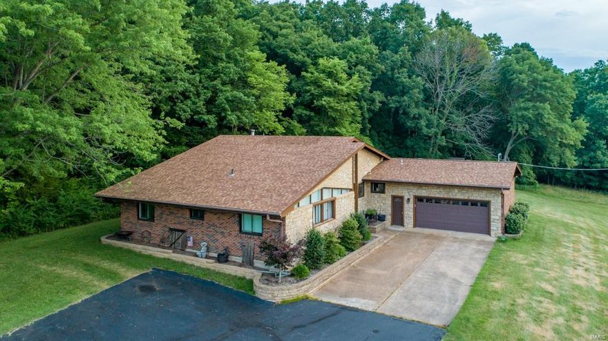 Located in Barnhart, Missouri is 116 acres wooded and pastureland with a beautiful move in ready home and outbuildings. 
The private gated property has a ¾ mile paved road that leads you to this custom built 2,380 square foot brick and stone residence overlooking the property. 3 bedroom, 3 ½ bath home also features an open floorplan with a full stone, high efficiency wood burning fireplace with ceramic tile and hardwood floors throughout. The expansive kitchen is appointed with custom hickory wood cabinets and granite counter tops. This home features 500-amp electrical service, plus an oversized two car heated garage.  

The property is set up to be energy independent with 148 solar panels to generate most of the electrical needs. With four 1,000-gallon propane tanks in reserve to provide fuel for backup generator and three wells.  

Conveniently located a ½ mile from Hwy 21, only ten minutes to I-55, 15 minutes to I-270 and only 
20 minutes to I-44.