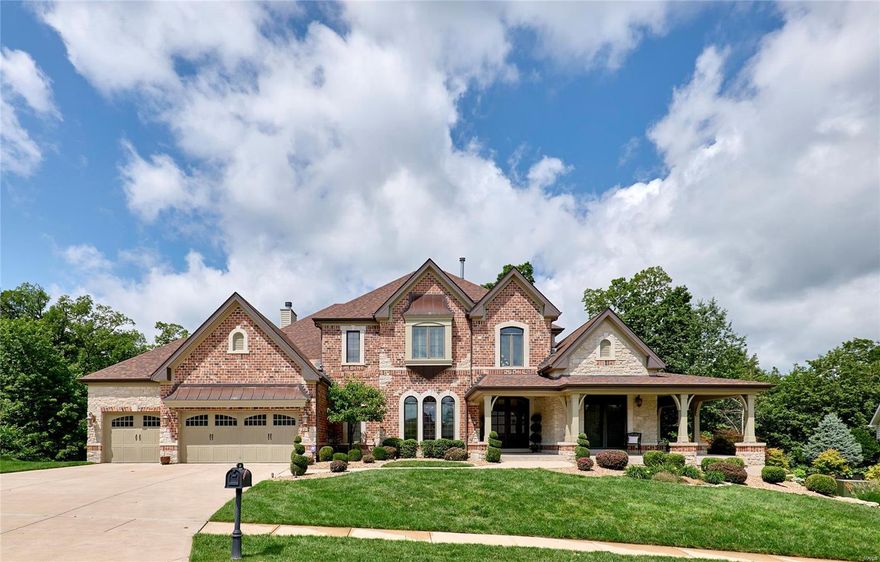 This professionally designed, immaculate 1.5 Story boasts of 6000+ sqft of living space built for entertaining & comfort! STUNNING curb appeal features a covered veranda w/stone accents. Cathedral entry foyer opens to the great room & window wall, formal dining rm or den/office & built-in bookcases. Chef's kitchen is complimented w/custom staggered cabinetry, granite counter tops, center island w/raised brkfst bar, dishwasher, gas cook top, pantry, VIKING refrigerator, microwave & double oven. The hearth & breakfast rooms adjoin offering an abundance of open space! The main floor master suite features his/her closets w/built-ins & luxury master bath w/corner tub, sep shower & dual vanities. Dual iron spindled staircases lead to the upper level w/bonus rm/loft, balcony, 3 additional bedrms, each w/their private full bath. The lower level is tastefully finished & includes a family rm w/fireplace, wet bar, rec rm, theater rm, 5th bedrm& full bath. 3Car Garage, Deck, Patio w/Fire Pit!