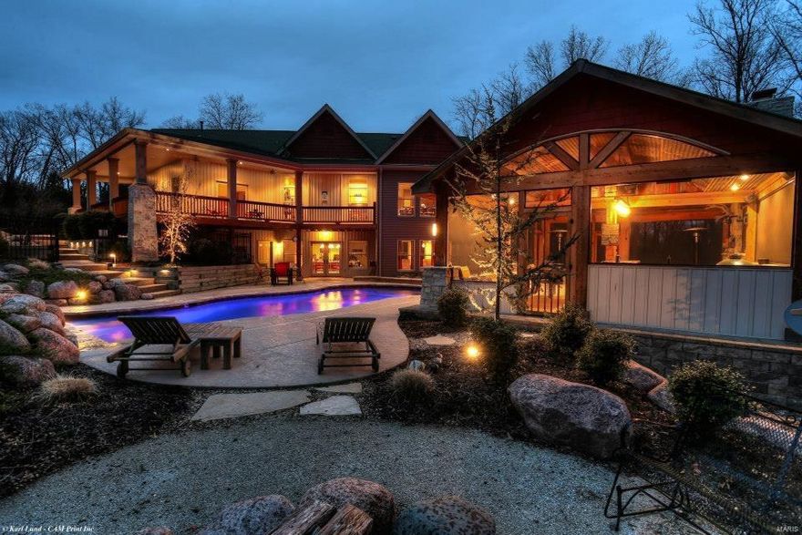 Incredible custom home, over 3 acres with 9 ft. surrounding porches so you can sit outside & enjoy the scenery. This home is one of a kind w/ an amazing salt water in ground pool & auto pool cover, incredible pool house with stone fireplace, bar, media area &  built in hot tub. The kitchen is top of the line with Wolf & Subzero appliances, custom made cabinetry and granite counters open to the great room. The doors are all 9 ft. tall solid wood & gorgeous hard wood floors are unique, native MO Oak  & they used the whole tree. The master suite has private deck & master bath has a lovely claw foot tub & large walk in shower. This home has every upgrade including Pella windows, epoxy garage floor,  circulating pump for instant hot water, wine cellar in the lower level, steam room,media area, large office and 2 additional bedrooms for a total of 5.  Wait until you see the beautiful BARN that is heated & AC with a workshop and large enough to hold a 32 ft RV.  STORY COMING SOON