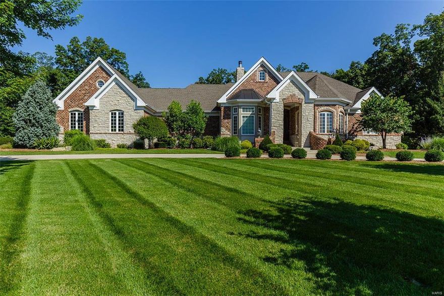 Exquisite Brick & stone elevation, circle drive, custom ranch home, nestled on 3 tree lined wooded acres. No details have been left out! Mahogany entry door, soaring ceilings, crown molding, formal dining room w/butlers pantry, den w/built in's, great room w/fireplace, & wall of windows (all have low E-tint). Arched doorways, hearth room w/fireplace, breakfast room, gourmet kitchen w/center island, walk in pantry, upscale appliances, custom 42" cabinets, ceramic tile, large laundry room, custom coat nook, large deck, main floor master suite w/sitting room, luxury master bath w/ his & her sinks, walk in closets, soaking tub, custom walk through shower w/jets, & wall heaters. Lower walk out w/two large bedrooms, two full baths, wine cellar, game area, work out room, theater area, fireplace, craft room, storage areas, entertainer bar, & more. 3 Car oversized garage w/stairs to large loft overhead. This home has too many features to mention! Call today for your private showing.