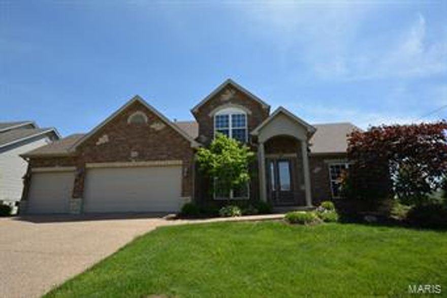 WELCOME HOME! Stunning 4BR 2.5BTH 1.5sty that shows like a display! A picturesque setting w/massive curb appeal offers brick/vinyl front, covered porch w/stately columns, lush landscaping w/irrigation system, 3 car garage & an IN GROUND POOL! Walking in the grand entry foyer w/gleaming HW floors, you'll see the elegant dining rm. The vast great rm has tall ceilings & gas FP flanked by windows. You’ll love the kitchen w/custom cabinets, tile backsplash, breakfast bar, stylish black appliances, pantry & breakfast rm. Enjoy the hearth rm w/a WB fireplace & door to the fenced backyard featuring an in ground pool w/patio perfect for outdoor entertaining & enjoyment. MF master suite offers a walk-in closet & deluxe BTH w/dual sink vanity, soaking tub & sept shower. Upper lvl has 3 add'l BR, full BTH & den.The partially finished LL w/rough-in for BTH offers a family rm & rec rm bringing your total livable space to 2660+SF.  Great location w/easy access to major hwys & Wentzville Schools!