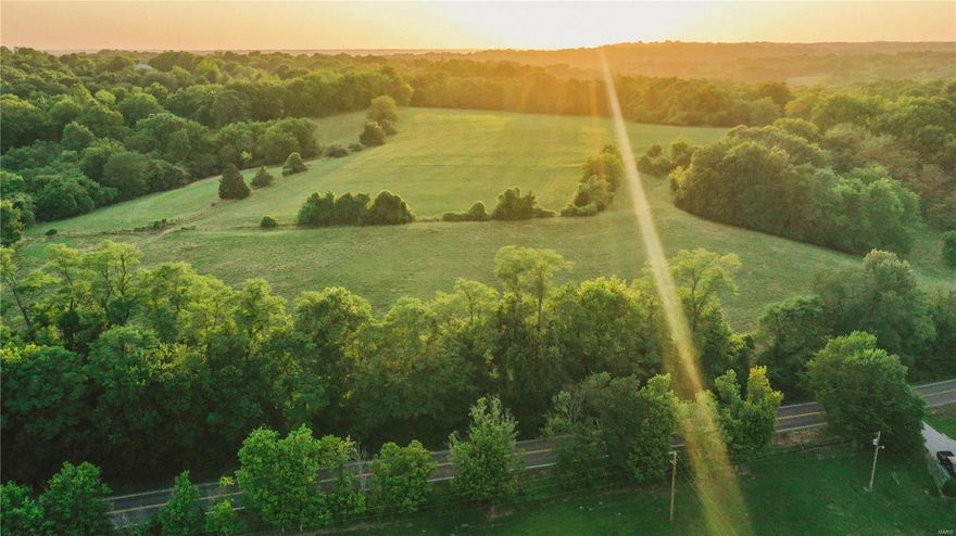 This gorgeous 94.76+/- acre property is located only 10 miles outside of Columbia proper and consists of rolling terrain with a 50/50 mix of open pasture and mature hardwood trees, including over 1,500 feet of feeder creek merging into the Missouri River only 1 mile away. As you admire the stunning views, you will immediately take note of the seclusion and privacy this acreage has to offer with paved highway frontage. There are 2 ponds including one nearly half of an acre. The 2nd pond is a wildlife pond. The location of this acreage is second to none!

There is an older 3 bedroom 1 bath farmhouse and outbuildings just off the paved highway. This home was originally built in approximately 1912 and consists of 1417 sq/ft serviced by a working private well and electricity. A detached garage, 2 hay barns and mobile home are located near the front of the property currently being used for storage. This property is being sold as-is. Schedule your private showing today!