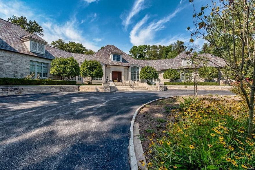 As you drive up the long approach to this palatial stone beauty, you are overtaken by its elegance and the stately way it tucks itself into 3 acres of private woods. Built by Higginbotham Bros. with approx 8400 sq ft, this one story home in Ladue imbues style and elegance at every turn. The light filled foyer with an Italian limestone floor gives way to a stunning living room with a magnificent carved marble fireplace from an 18th century European chateau. Evident throughout the home is the conscious balance between sophistication and convenience, from the impressive and peaceful art gallery to the retreat area including an office with a wood and granite fireplace, an impressive billiard table setting, and a spa/workout room. Designed for entertaining, this estate includes a kitchen with endless amenities and a generous party room with breathtaking views. The idyllic surroundings and meticulous attention to detail make this home a rare gem and a perfect place for any family.