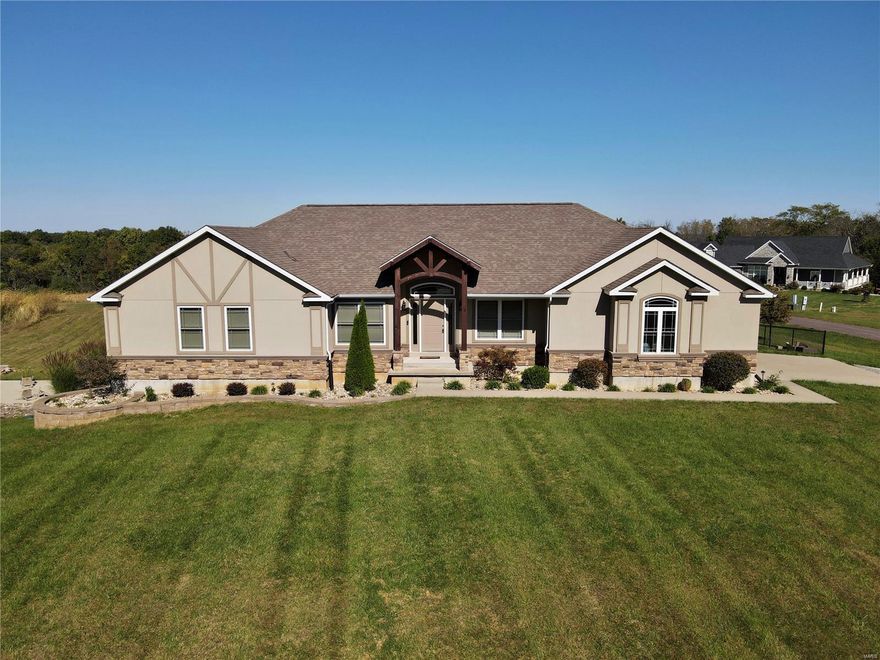 **MOTIVATED SELLERS** 
The word your looking for is "WOW!" This 2013 custom built home is wide open and offers a grand view of the wide open living, kitchen, and dining area.  Kitchen is loaded with cabinet space and the spacious granite countertops make entertaining easy and inviting. Custom features like hand scraped oak floors, man cave with wood burning fireplace on the main level, and vaulted ceilings give this home a one of a kind look that you can be proud of.  The lower level features another bedroom, HUGE closet, and full bath, and a family room with electric fire place.  There is plenty of storage space in the unfinished section of the basement or it could be finished to provide additional living space.   If the price of building a new home seems daunting, this already built home still feels like new and is waiting for you!  Call to view today.