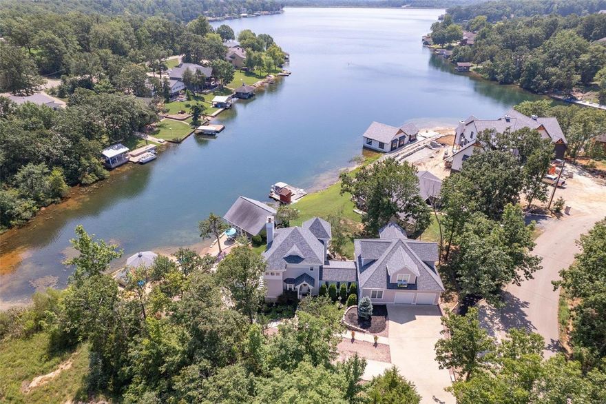 One-of-a-kind LAKEFRONT oasis in TerreDuLac on highly sought after Lac Capri, 1 hour south of STL. Custom built retreat designed by a structural engineer. 4+beds, 4 full baths, 2 fp & 3967+/- sq ft! Sleeps 12 comfortably. Kitchen has cntr island, solid tops. Dining features an open concept w/ floor to ceiling windows. Main floor has full bath w/curbless shower, dblbowl vanity, & signature hardware fixtures; laundry room & primary suite w/ green fp. The 2nd floor has primary suite w/ wb fp & full bath w/ step-in shower & vanity. Attached carriage house creates loft living space-3 beds, lounge area, full bath, shuffleboard, & work station. Walkout basement has livingrm, full bath, laundry room, bedroom & sunroom. Heated 2 car attached garage. 2 decks. Alarm system. Lush landscaping, sand beach, gazebo, decorative ponds w/fountains, hot tub, boat house has slip, electric lift, '06 twin engine SeeDoo Utopia. Home comes furnished. Privacy abounds in this architectural masterpiece! Additional Rooms: Sun Room