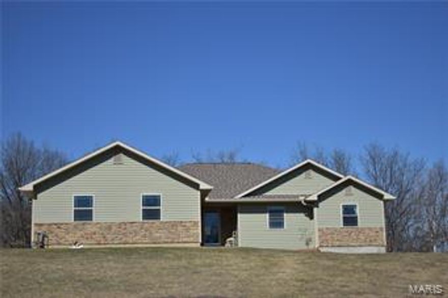 Beautiful property on the outskirts of town with 8.41 acres of privacy.  Constructed in 2012 this 4 bedroom 3.5 bath home has so much to offer.  Main level offers three bedrooms, 2 full baths and 1 half bath just off the kitchen.  Semi open floor plan with spacious living room, custom Maple cabinets in the kitchen with stainless steel appliances and granite top island with bar seating.  Walk-in pantry with electricity is great for additional cooking space.  Access the partially covered deck from the kitchen which overlooks the rolling hills and an abundance of trees.  Master suite has beautiful bathroom with ceramic tile walk-in shower, jetted tub, and his and her closets. Full finished basement with bedroom, walk-in closet, full bath with ceramic tile walk-in shower, family room and rec area.  Safe room in the basement is fully concrete and is spacious enough for an office.  Walk-out basement and third car basement garage are a plus!  Well constructed and ready for YOU!  Call today!