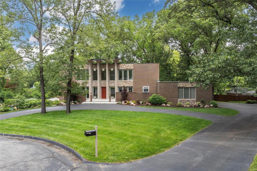 Spectacular mid-century modern, 2-Story home, situated on a beautiful, wooded 1.75-acre park-like, cul-de-sac lot, in the heart of Frontenac. 5 Beds, 5.5 Baths & 5,100+ sqft of total living space including the finished Lower Level.2-Story Foyer with terrazzo floors & beautiful floating staircase! Main Floor boasts Living Room with custom moldings; Great Room with dramatic stone FP, huge windows & formal Dining Room with full view, sliding glass doors. Kitchen with custom cabinets, granite, tile backsplash, breakfast bar & top of the line SS appliances, as well as a Breakfast Room & a lovely Powder Room, complete 1st Floor. 2nd Floor finds hallway with wall of windows, leads to Master Retreat with Sitting Room, a spa-like Master Bath & dual walk-in closets. Awesome LL with large Rec Room, wet bar, brick accent wall with built-in FP & full view sliding glass door, the 5th Bed, 2 Baths & walk-in cedar closet. Relax in your private oasis & enjoy the free form in-ground pool!