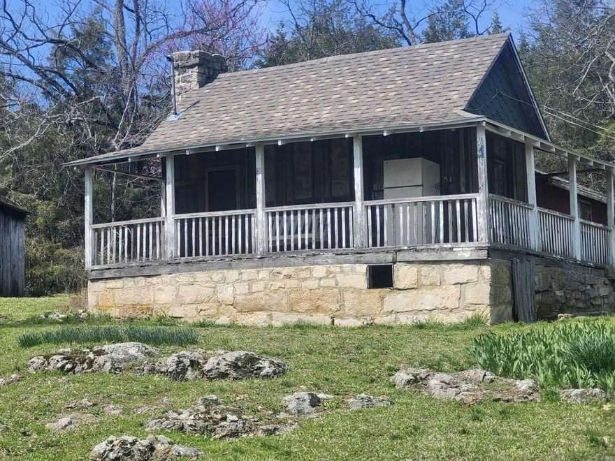 ONE OF A KIND RIGHT HERE!!!!! A river runs through this 418-acre farm for sale in South Central Missouri, with a nostalgic cabin from back in time that offers seclusion. Land is wooded with Large Walnut and White Oak Timber and offers some open bottom ground as well. Property is perimeter fenced with good road frontage and creek running through the farm offers abundant water all year long. There is multiple springs with a Spring House that has been there for years, and the water runs strong. Enough open land to run livestock of your choice and cut hay. This is a HUNTING PARADISE. Wildlife everywhere you look! You will also discover a couple caves for exploring. The history runs deep just like the creek here. There is a well with running water. This is a TRUE OZARKS PROPERTY! Don't miss the opportunity!