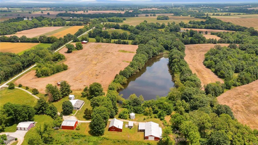 70 Acre Property, “St. Paul”, St Charles County, MO Set your sights on this rolling 70-acre property located in Prestigious St. Paul, St Charles County, MO. The acreage consists of 36 acres wooded, 30 acres tillable, farm ponds, and Features a Pristine 4-Acre Secluded Lake. Stately set on the property is a One-of-a-Kind 3 bedroom, 2 bath Cottage with All Amenities. A newer 50x30 Building, Vintage Loft Barn with Workshop, Open Front Barn, Grain Bin, and Shed including a Full Functioning Shop Heated and Cooled. With its mix of Woods, Tillable, and Water Sources makes this property ideal for Trophy Buck and Wild Turkey Hunting. Just Imagine yourself sitting back on your own property overlooking your Private 4-acre lake after a day of Hunting, Horseback Riding, or just spending time in your Own Shop. This Priceless Property has it all. Only 10 minutes from O’Fallon, MO.