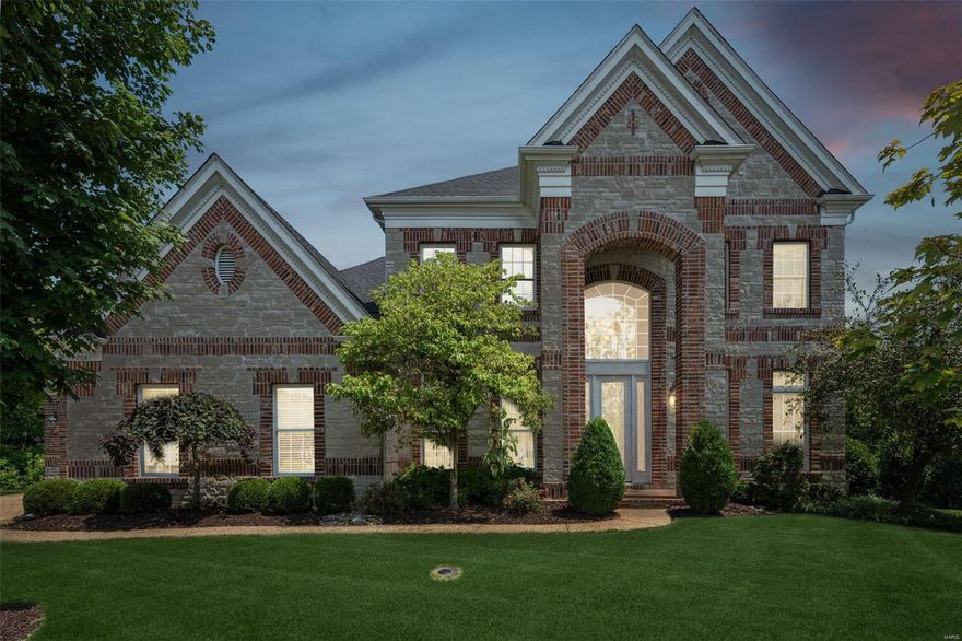 Immaculate updated brick/stone home with breathtaking views. Grand 2-story marble floor foyer welcomes you to a magnificent great room. The custom mirror above the fp, the soaring ceiling and the wall of windows amplify the sense of space and opulence. A double tray ceiling, wainscoting panels & crown in the tastefully designed dining room give it an extra layer of depth . The gourmet kitchen features granite counters, custom cabinetry, w/I pantry and a hearth rm w/another inviting fp. Start your day in the breakfast rm or step out thru the bay door & windows and enjoy tranquility on the large newer composite deck. Retreat to the master suite with coffered ceiling, bay window, luxury bath, his/hers W/I closets. The UL has 3 well-sized rooms and 2 full baths. Finished w/o basement features custom bar, rec rm, br, full bath, media/extra rm. The lg covered patio & fan is perfect to unwind & enjoy the sunsets. 10' ceiling on all 3 levels, this is the ultimate entertainer's dream Home!