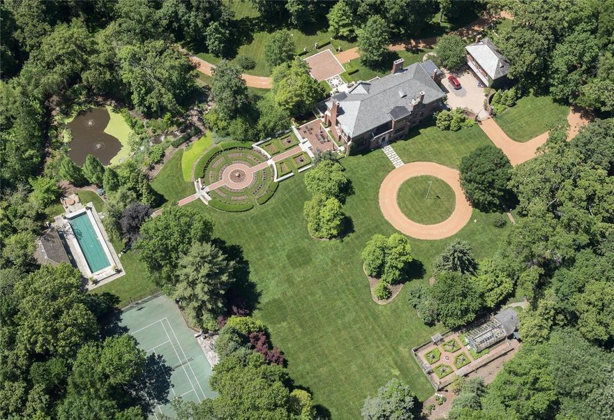 Resplendent and World Class. An 8 acre Ladue Estate where every need is met, every expectation surpassed. Hallmark features include gently rolling grounds, terraced gardens, a tiered waterfall and tranquil pond. The lap pool and pool house are exceptional; a lighted tennis/sport court and greenhouse, iconic. Formal rose gardens and organic vegetable gardens complete the setting. Rich history fills a main house of 10,000 SF in intrinsic architectural detail, transformed by the owner's accommodations to a modern lifestyle with an updated kitchen detailed in finest finishes. The primary suite is a lavish retreat with dual baths and dressing rooms. Smart Home features, a finished Lower Level, and comprehensive security are other key notes. A Carriage House provides ideal guest lodging. Reimagine intimate dinners, gracious receptions and extravagant fundraisers; a bespoke residence at a singular level that is nothing less than remarkable and breathtaking. Please hit Virtual Tour Link/video Additional Rooms: Wine Cellar