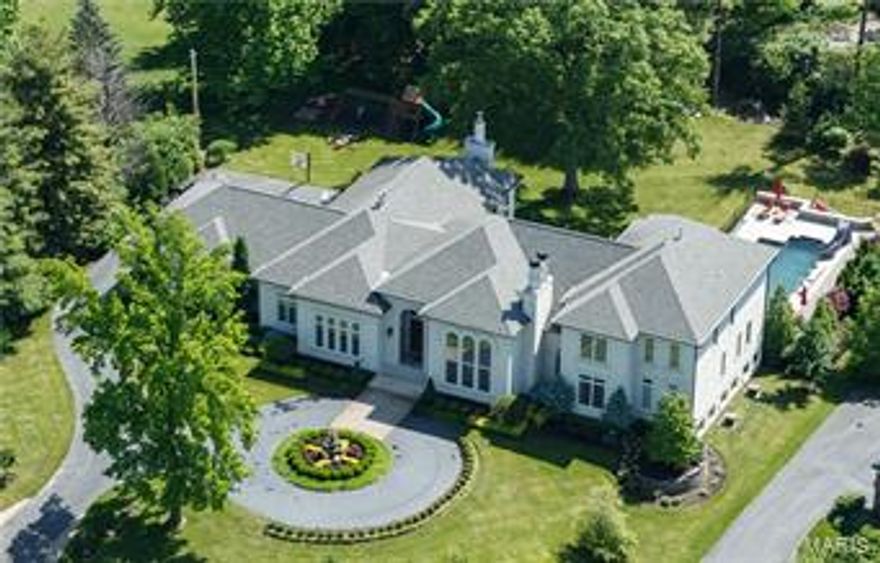 Off Clayton Road in Frontenac. Modern Custom w/ "Smart" electronics. 8200SF total living. Resort lifestyle. 5BR/6BA, New pebble tec pool, stamped concrete patios, waterfalls, fountains & slide. Refined sophistication w/highest level finishes. Two-story entry opens to a bank of French doors leading to 1000SF covered patio & terrace, formal gardens & grounds. Kitchen features 2 islands, Viking, SubZero, Fischer Paykel, Hearth Room, brkfst room & walls of windows cascading natural light. Main level Master w/luxe bath & room-sized closet. Flooring of exotic woods & stone. Made-to-order lighting. Designer paint, millwork, & faux finishes. Sweeping 15' & 17' ceilings. 2nd level: 3 en-suite BRs & play area. Lower Level: professional Exercise, Media, & Billiard Rooms, full spa bath w/steam shower & rm for future Wine cellar. Main level laundry & planning rm. Expanisve grounds, w level flat yard. Minutes  to sophisticated shopping & dining at Plaza Frontenac, steps to Highway 40. Additional Rooms: Mud Room, Sun Room