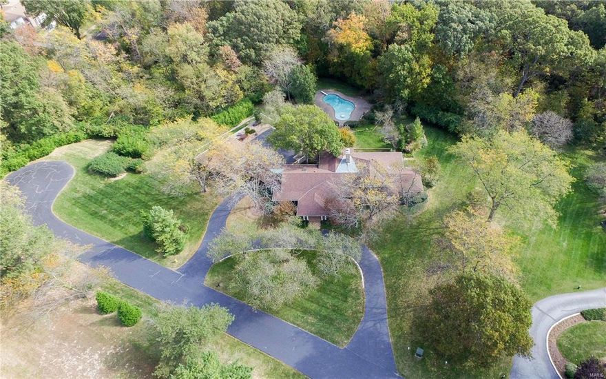 Serene Setting!   Special Price for Neighborhood.  Fantastic Cul de Sac Location.   Acreage Plus 6000+ Square Foot warm and Charming Home with a Close In Location in Chesterfield.    AND this is a HIGGENBOTHAM HOME Built with Quality Throughout!   So Many Outstanding Features:   Hardwood Floors, Sprinkler System, Security System, In-Law Quarters, Central Vacuum, Workshop, Thee Car garage, Office/Dark Room, Five Bedrooms, Four Full and Two Half Baths, Two Fireplaces, Vaulted Beam Ceilings, INGROUND POOL WITH A FANTASTIC SETTING.   This Home is Ideal for Raising a Family.   A Private Retreat with ALL the Amenities of Great Schools, Shopping, Hospitals, Clubs, Close By.   Million Dollar Plus Homes Surround You!!!   A QUIET RETREAT!   Feels Like You are on Vacation.