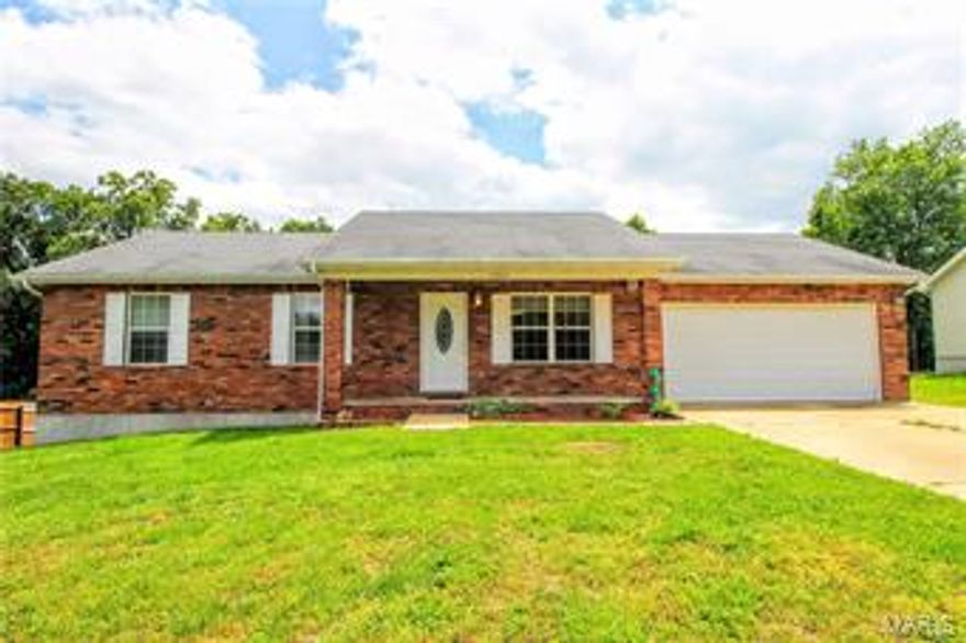 Priced to sell. This is a gorgeous 3 bedroom, 2 bath home located in a wonderful subdivision in Waynesville. The living room is extremely spacious and features a beautiful brick gas fireplace. There is an awesome laundry/mud room right off the garage. You'll find gorgeous wood laminate floors in parts of the home and carpet in the bedrooms. All of the bedrooms are large and the master bedroom has a large walk in closet and a master bathroom suite which features a double vanity, and a tub/shower combo. There is a covered porch in the front of the home, a large deck off the back of the home, and a spacious flat yard! Give us a call today to view this home! Seller is offering up to $445 of American Home Shield Warranty!