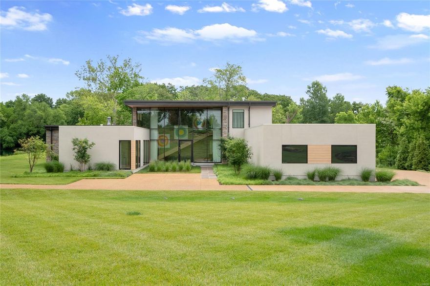 Perched on 1.67 private acres in the heart of Ladue, this stunning 4-bedroom, five-bath contemporary home will impress even the most discerning of buyers. This home soaks in private lakeside views just a stone’s throw from the Bogey Club golf course. A gorgeous gallery stone wall w floor-to-ceiling windows & a floating staircase greets you upon arrival. Retreat to the sunken living room & select from a carefully curated collection of books found on the room's mid-century modern, built-in shelving. The heart of the home combines the dining room, hearth room and kitchen in a seamless design w luxury finishes adorning every element within. The kitchen hosts Sub-Zero & Wolf appliances, custom quartz countertops and a fabulous butler pantry designed to make any chef swoon. Two primary ensuite bedrooms grace the main level along w the spacious laundry/mudroom. Upstairs, enjoy two additional ensuite bedrooms, a cozy family room and a lovely deck overlooking the mature forest and lake below. Additional Rooms: Mud Room