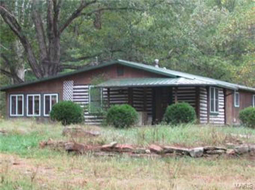 Great Recreational Retreat or Homestead Property! This property joins the National Forest on 2 sides and has Courtois Creek frontage. Water and electric in the barn and shop.  The shop includes heating, cooling and a kitchen.  There is a stocked pond, 12x8 playhouse and a 12x16 treehouse.  The barn includes 6 stalls, tack room, heated waterer and corral. Approximately 1/3 of property is fenced and there is a great garden spot.  The home has an updated kitchen and bathrooms.  The master bedroom includes a walk- in closet, a full bathroom and access to the 13x24 covered deck.  This property is very close to Berryman Trail and Ozark Trail and has an abundance of wild life and trails throughout.