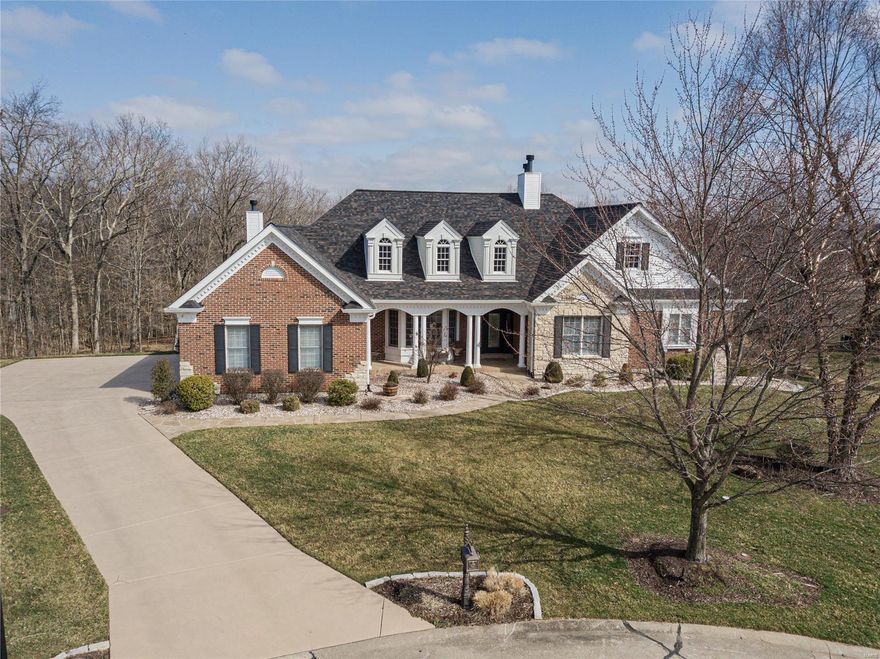 Show me the money!? The pictures are a small taste to wet your whistle! This is a stand alone one of a kind domain in Lake St. Louis right off the HWY 40 corridor in the back yard of Chesterfield Valley! On display is all the heavy hitters! WOLF appliances, HICKORY floors, SUB ZERO fridge, ANDERSON windows, TIGER WOOD decking, Newer DUAL systems, GRANITES dripping in every LAVATORY,  WET BAR & KITCHEN. NEWER architectural roof, 3 FIREPLACES, DOUBLE ovens, PROGRAMMABLE AUTO BLINDS, SURROUND SOUND inside AND OUT.  TOP OF THE CABINETRY LINE, equipped w/roll outs, DOVE TAIL drawers & SLOW close drawers. Newer Interior & exterior DOORS. All new KOHLER fixtures throughout. OPEN EXPOSED WOOD TREAD STAIRCASE & spindles to FULLY FINISHED LOWER LEVEL WALKOUT w/ MAN CAVE, EXERCISE ROOM with a VIEW and HOBBY AREA. CUSTOM CROWN ceilings, 22,000 gallon POOL with newer COOL DECKING surround, COVER & PUMPS. Pack your bags, planes and delays? Or a STAYCATION -RIGHT HERE AT HOME!