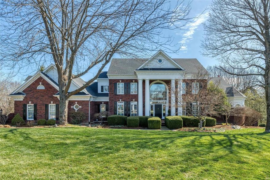 Stately 1.5-sty Georgian Colonial on 2.35-acre grounds. Center hall floor plan features red oak hardwoods, soaring ceilings, detailed trim work & plantation shutters.  Impressive 2-sty foyer leads to formal living & dining rooms & stunning great room with marble see-through fireplace flanked by built-in bookcases, wet bar & wall of windows with private wooded views. Designer kitchen with cherry cabinetry, quartz countertops & 6’ center island adjoins breakfast room with convenient planning center & floor-to-ceiling brick fireplace. Vaulted primary bedroom suite with luxury bath & adjacent study with fireplace offers an appealing retreat. T-staircase accesses 3 additional ensuite bedrooms & bonus room. Lower Level includes recreation room, game room & gathering bar plus workout room & full bath. Atrium doors open to outdoor living area with deck, patio, pool and hot tub surrounded by extensive landscaped gardens, waterfall and pond. Private street with 13 homes and exclusive HOA.