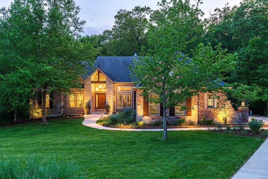 Spectacular atrium ranch with over 4600 sq ft of living space enhanced by superior craftsmanship & distinctive architectural elements throughout. Expansive windows capture intimate views of the natural surroundings while beamed ceilings, hickory hardwoods & designer lighting provide a sense of rustic elegance. Impressive entry foyer leads to formal dining room & stunning great room highlighted by floor-to-ceiling stone see-through fireplace. Karr Bick-design kitchen with Mouser cabinetry, soapstone countertops, commercial grade appliances & wet bar adjoins breakfast room with stone fireplace, 10’ island & copper sideboard. Vaulted master bedroom suite with wide bay window & marble bath with freestanding tub plus 2 additional bedrooms & hall full bath complete the main floor living quarters. Walk-out Lower Level includes recreation room with wet bar, game room, media room & guest suite. Situated on 3+ wooded acres with screened porch, 2 decks (1 with fireplace), fire pit & 4-car garage.