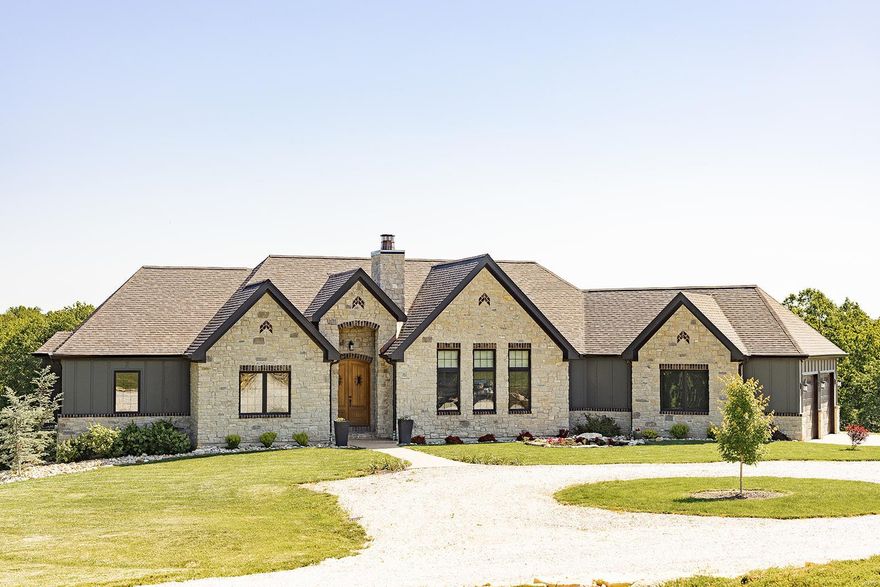 This one-of-a-kind custom home was built in 2021 & is a timeless blend of style - the warmth of a rustic farmhouse & the elegant features of today's most modern homes. Entering the massive mahogany front door, you will immediately recognize the attention to detail & custom features throughout this 4,000+ sqft home. Decorative wood truss beams, tongue & groove ceilings, coffered ceilings, stone FP, hand hewn beams, & premium engineered hardwood floors. The kitchen features distressed solid wood cabinets, granite countertops w/ rock face edging, copper sink, & GE Cafe' platinum finish appliances. The MBD is a great retreat w/ private access to the large 20x13 covered deck. The MBA features a 6' copper soaking tub & walkthrough shower w/ full body sprays. Let's not forget the theatre rm w/ 7-point surround, family rm w/ bar, extra bdrm, & safe rm. This timeless treasure is nestled on a hill overlooking a beautiful, wooded haven of 20 Ac m/l w/ creek, food plots, and home to much wildlife.