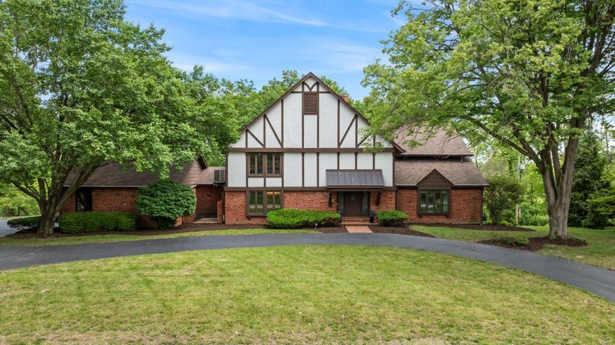 Experience luxury living in this exquisite English Tudor home on 2 acres backing to Westwood Country Club in prestigious Westchester Estates of Creve Coeur. This 5-bed/5-bath residence spans 6,000+ sq ft w/ timeless charm & unique features. The grandeur is evident from the 2-story foyer w/ period-style door, majestic staircase, beamed ceilings, & slate flooring. Enjoy Living/Dining/Great Rm w/ impressive features like peg plank wood flooring, vaulted ceilings, cozy gas f/p, wet bar, built-in wine cellar w/ gated door. The gourmet Eat-in Kitchen is a chef's dream w/ period-style cabinetry, granite counters, multiple pantries, island, & high-end appliances including double oven & 5 burner cooktop. The Master suite offers luxury amenities, while the upper level bedrms are spacious & accessed by remodeled baths. Entertain in finished walkout LL w/ a bar & half bath. Add'l features include: 4-car garage, circular driveway, zoned HVAC ('23), screened-in porch, & lake access. Welcome home! Additional Rooms: Sun Room